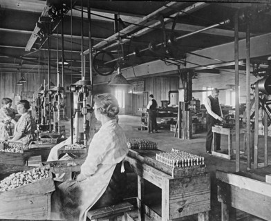 Men and women working at the Express Spark Plug Company ca.  between 1910 and 1926