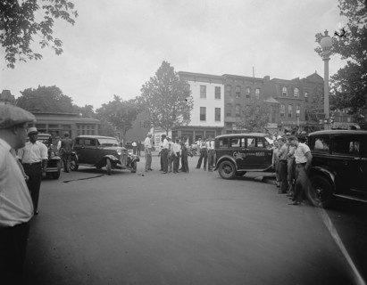 Street scene, people milling around after an auto accident ca. between 1910 and 1935
