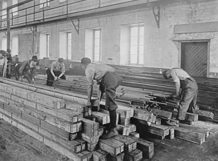 Early 20th century men working with lumber ca.  between 1910 and 1926