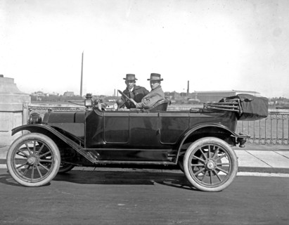 Two men driving a Briggs Detroiter automobile, [Washington Monument, Washington, D.C., in background] ca.  between 1910 and 1925