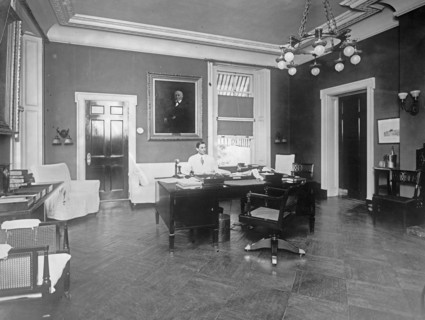 William Gibbs McAdoo sitting at his desk ca.  between 1910 and 1935