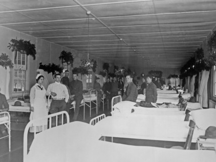 Soldiers and nurse in military hospital, during Christmas season ca.  1910