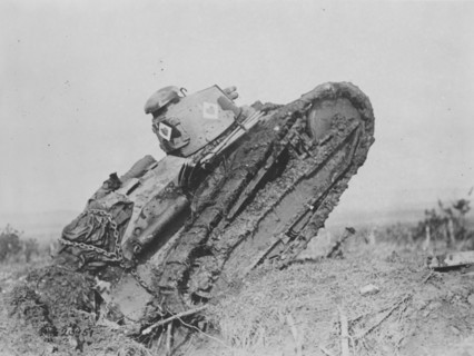 A tank ploughs its way through a trench and starting toward the German line, during World War I, near Saint Michel, France ca.  1917
