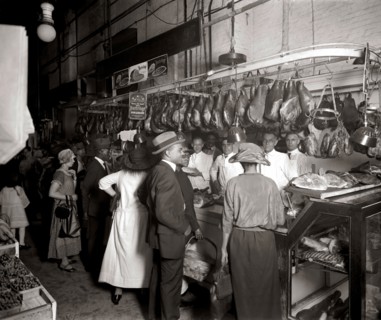 Customers at D.D. Collins meat stands (Stands 94 and 95) at the O Street Market located in the Shaw neighborhood of Washington, D.C. ca.  1915