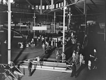 People enjoying a fund day at an emusement park (fun house and spinning wheel) in Glen Echo, Md. ca.  between 1910 and 1935 (probably 1928)