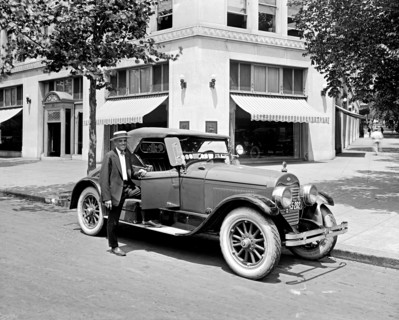 Man standing next to his Ford Motor Company, Lincoln Roadster ca.  between 1910 and 1935