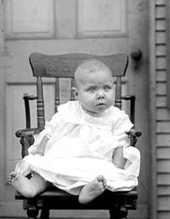 Young baby sitting in a chair  ca. between 1909 and 1919