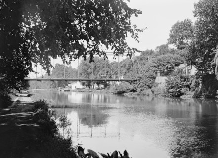 People walking across the Chain Bridge over the C&O Canal ca. between 1909 and 1923