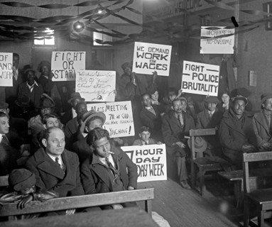 Communist Protesters in early 20th century, Communist Young Party Communist League meeting holding up protest signs like Fight or Starve and 7 Hour Work Week ca. 1925