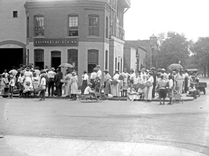 People waiting in line for ice outside the Home Ice Company ca. between 1909 and 1920