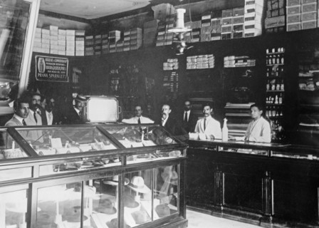 W&R Store of a British importer, workers standing behind a display of hats ca. between 1909 and 1919