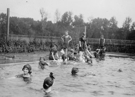 Kids swimming in the municipal bathing beach / swimming pool ca. between 1909 and 1919