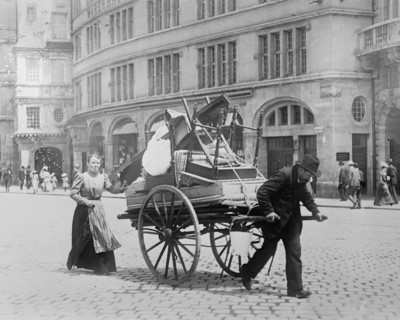 Man and woman moving their household belongings through the streets on a cart in Berlin Germany  ca. between 1909 and 1920