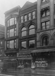 Exterior of People's Drug Store, 11th and G Streets, Washington, D.C., with other shops ca. between 1909 and 1932