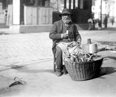 A man in the street selling bread & sausages in Vienna Austria ca. between 1909 and 1920