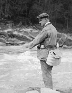 Miles Poindexter fishing in a river ca.  between 1918 and 1920