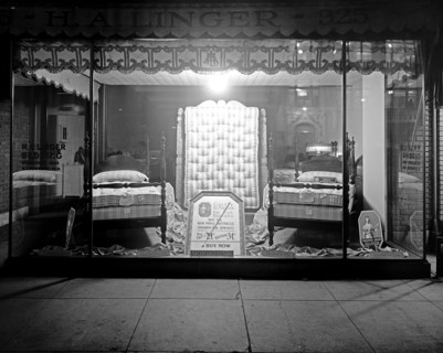 H.A. Linger store window at night, featuring bedding and matresses ca.  between 1918 and 1928
