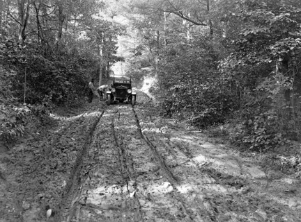 Duplex truck having tired fixed on a backwoods road ca.  between 1918 and 1921