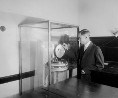 Charles C. Wylie setting back clock at Naval Observatory ca.  between 1918 and 1928
