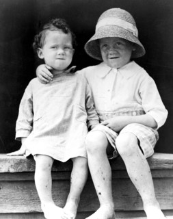 Two children, seated on step ca. 1909