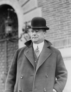 Senator Hiram W. Johnson, half-length portrait, standing, facing left, wearing bowler hat ca. 1909