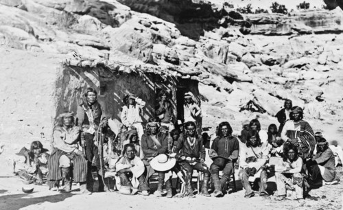 Paiute Indian group posed in front of adobe house ca. 1909