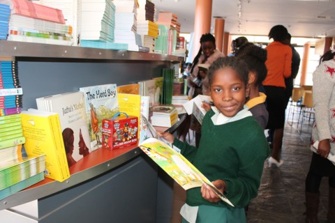 A Namibian school girl looking through a school textbook in a Namibia school ca. 20 July 2017