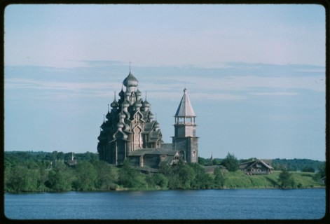 Pogost ensemble, Church of the Transfiguration (1714), and bell tower (19th century), northwest view, evening, Kizhi Island, Russia; 1993