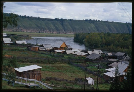 Log houses, with Belaia River in background, Bel'sk, Russia; 2000