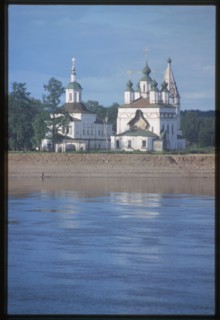 Church of St. Dmitrii (1700-09), and Church of St. Sergius Radonezh (1739-47), at Dymkova Sloboda, east panorama with Sukhona River, Velikii Ustiug, Russia 1998.