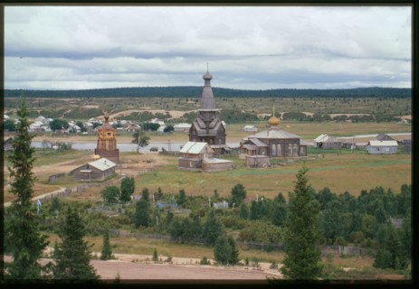 Northeast panorama with Church of the Dormition (1674) (center), and Church of St. Afanasii (1857) (right), with Varzuga River in background, Varzuga, Russia; 2001