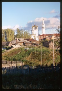 Church of the Trinity (1703-12), northwest panorama, with log houses (19th-20th centuries), and garden plots in foreground, Verkhotur'e, Russia 1999.