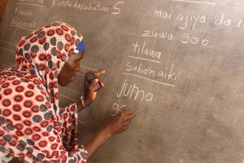 Niger - A woman in Niger writes on a chalkboard ca. 27 December 2015