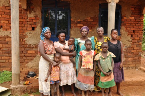 A household of four generations outside a building, possibly a home, in  Busakila sub-county Uganda ca. 6 March 2018