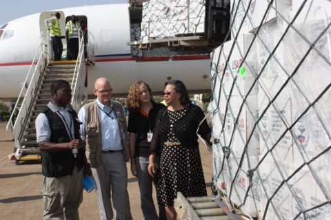 A USAID transport carrying 67 tons of humanitarian supplies arrives from Nairobi to South SudanA group headed by U.S. Ambassador to South Sudan, Susan Page, (far right) meet the emergency aid shipment...