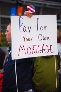 Attendees holding signs at a Tea Party rally in Dallas, TX (one of the first in the United States on Feb. 26 2009)
