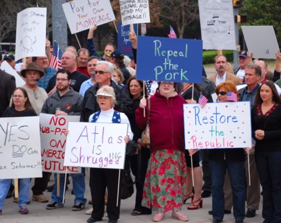Attendees holding signs at a Tea Party rally in Dallas, TX (one of the first in the United States on Feb. 26 2009)