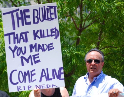Iranians in Texas taking part in a Freedom for Iran / Green Revolution rally at Dallas City Hall plaza in downtown Dallas, TX; protest signs ca. June 2009