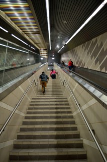 Passengers of a DART subway train climb the stairs of the Uptown station in Dallas, TX