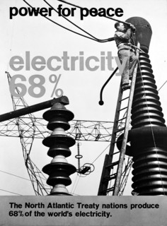 NATO poster with photo of lineman servicing electrical equipment