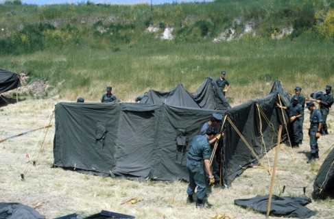 Marines erect a tent at a temporay housing facility for Vietnamese refugees.