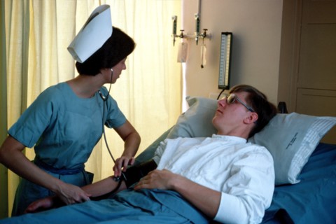 A US Army nurse takes a patient's blood pressure.