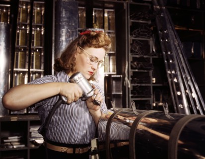 A woman operating a hand drill at North American Aviation