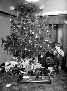 Boy on scooter in front of Christmas tree