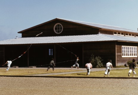 Boys flying a kite in front of community center