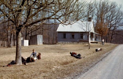 Children playing by road near school house