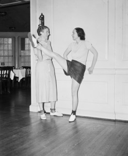 Dancer in a dance studio stretching her leg