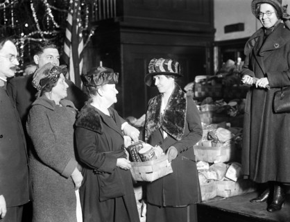 First Lady Grace Coolidge handing out Christmas baskets ca. 1923 or 1924