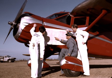 Instructor and students studying a map