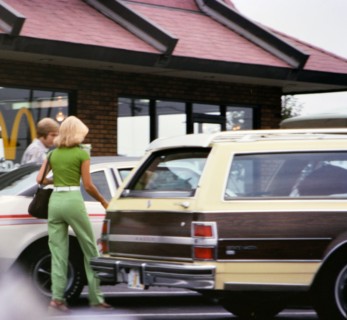 Man and woman entering their car after eating at McDonalds